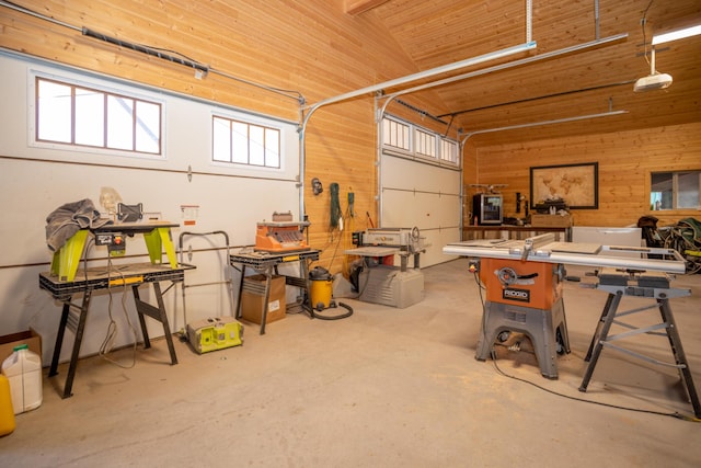 garage with a workshop area, wood walls, and wooden ceiling