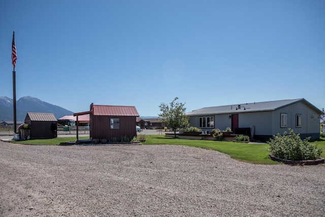 view of yard with a shed and a mountain view