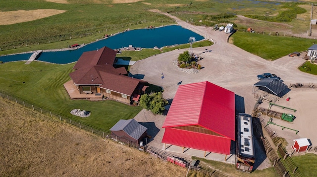 birds eye view of property with a rural view and a water view