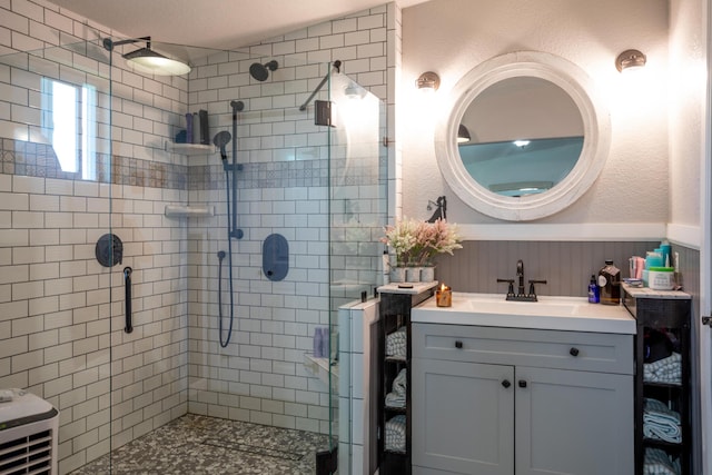 bathroom with walk in shower and vanity