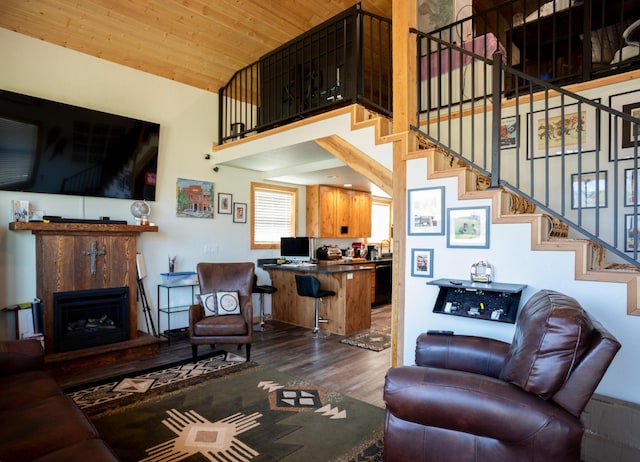 living room with wood ceiling, dark hardwood / wood-style floors, and a towering ceiling