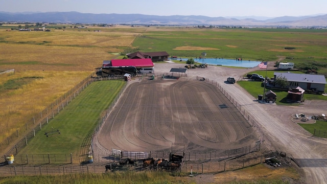 drone / aerial view featuring a rural view and a water and mountain view