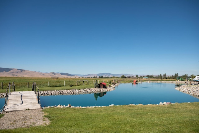 water view featuring a rural view, a mountain view, and a dock