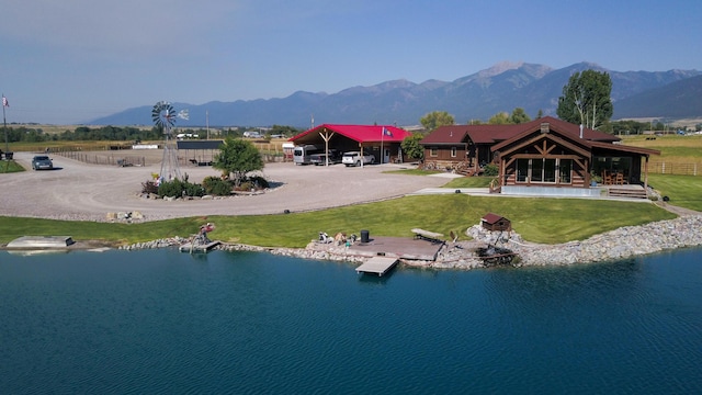 exterior space with a water and mountain view