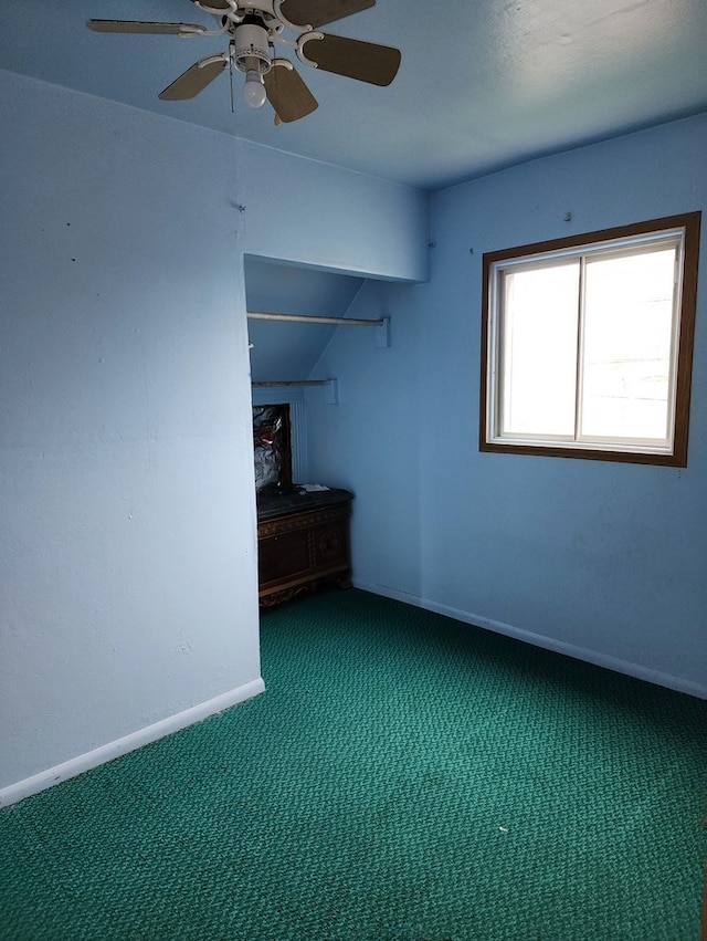 spare room with ceiling fan and carpet