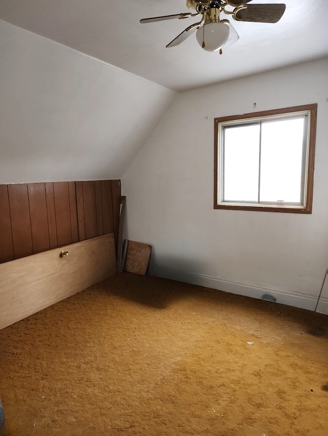 additional living space featuring lofted ceiling, ceiling fan, and carpet flooring