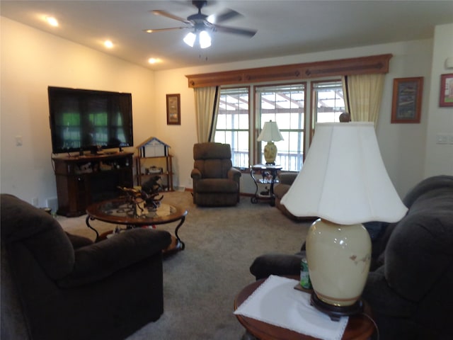 carpeted living room featuring vaulted ceiling and ceiling fan