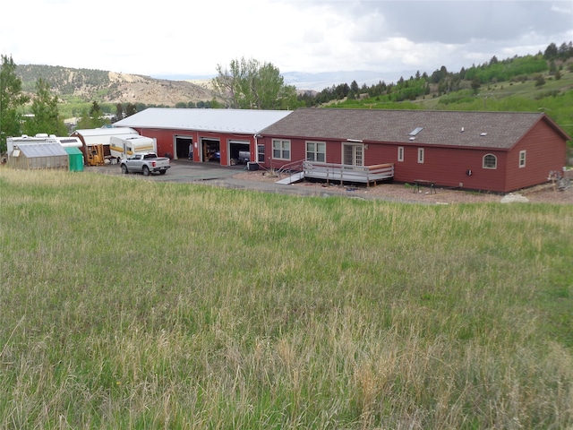 back of property featuring a wooden deck