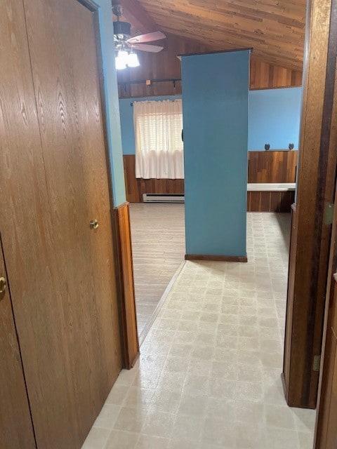 hall with light tile floors, wood ceiling, lofted ceiling, and a baseboard heating unit