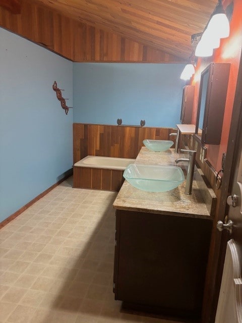 bathroom featuring wooden ceiling, dual vanity, tile floors, and vaulted ceiling