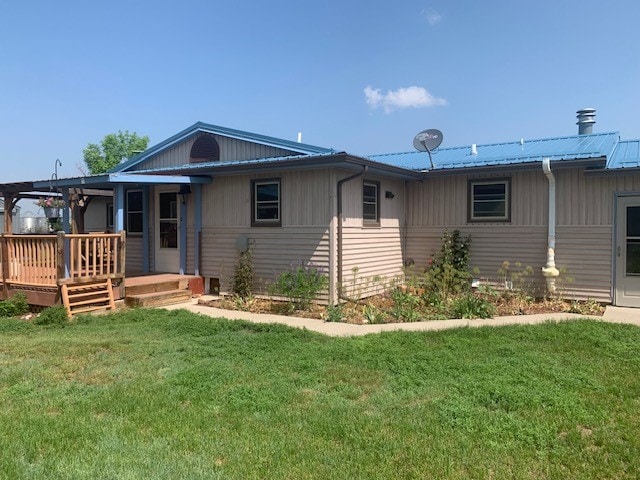 rear view of property with a lawn