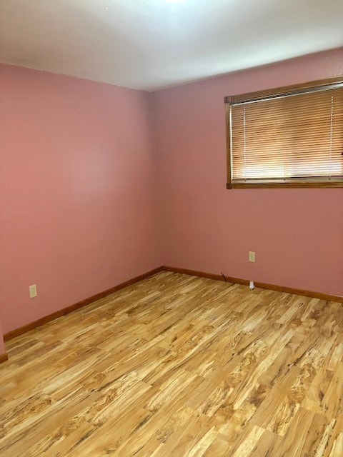 empty room with light hardwood / wood-style flooring