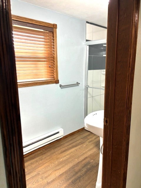 bathroom with hardwood / wood-style floors and a baseboard radiator