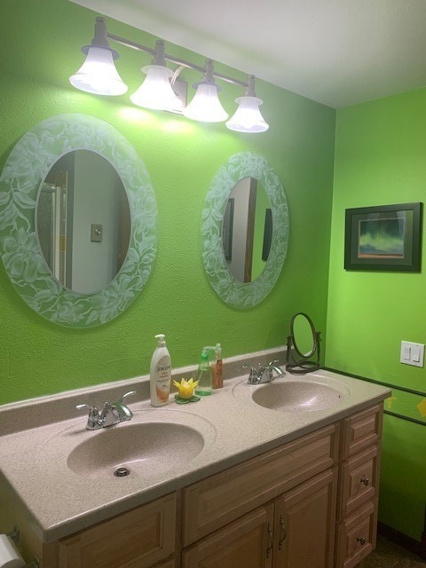 bathroom with oversized vanity and dual sinks