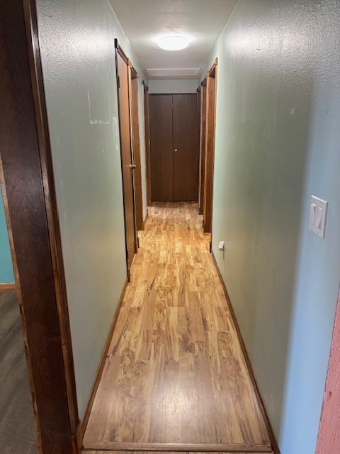 hallway with light hardwood / wood-style flooring