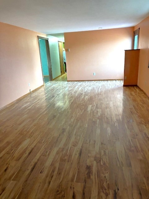 empty room with dark hardwood / wood-style flooring