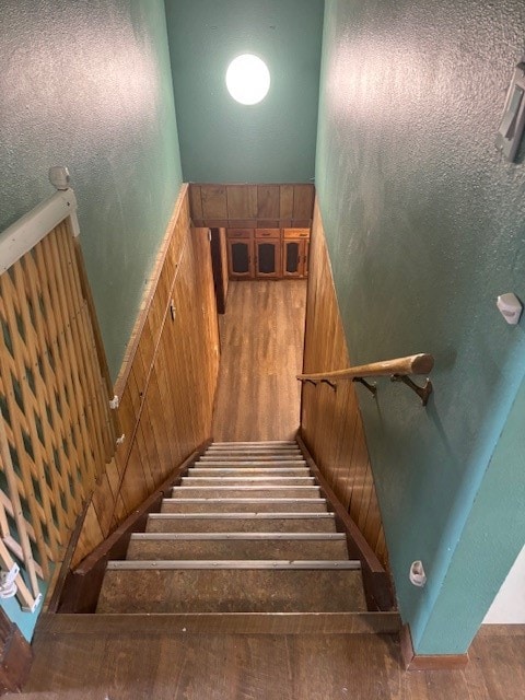 stairs featuring dark wood-type flooring