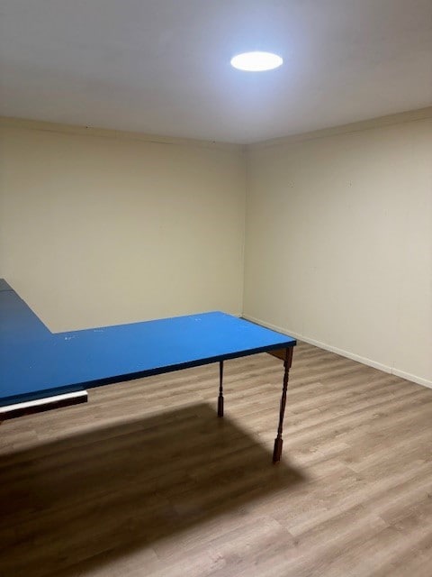 playroom with ornamental molding and hardwood / wood-style floors