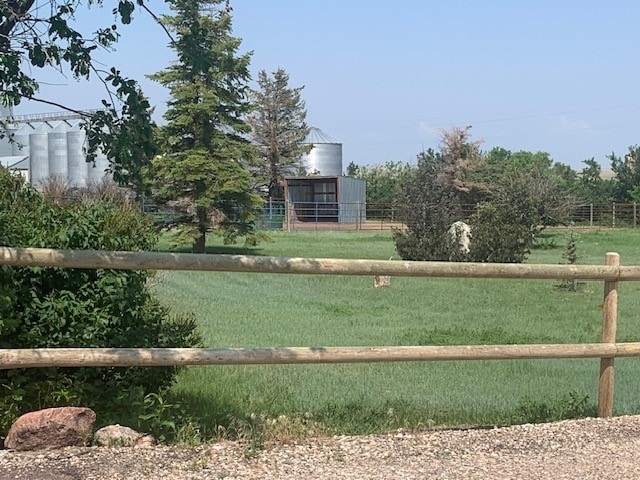 view of gate with a yard