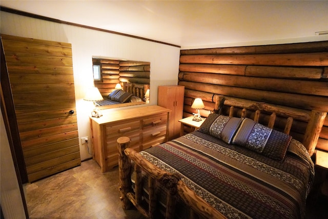 bedroom featuring log walls