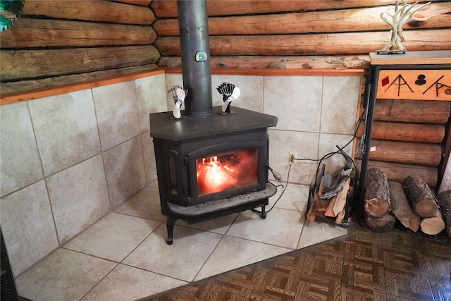 details featuring parquet flooring and a wood stove