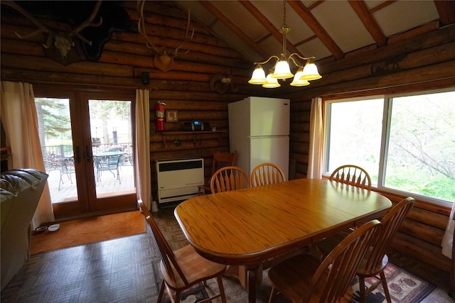 dining space with beam ceiling, plenty of natural light, a notable chandelier, and high vaulted ceiling