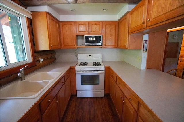 kitchen featuring built in microwave, white gas range, sink, and dark wood-type flooring