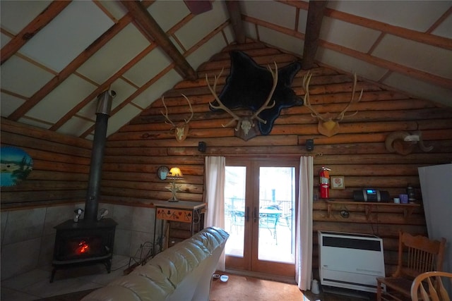 living room with high vaulted ceiling, heating unit, log walls, french doors, and a wood stove