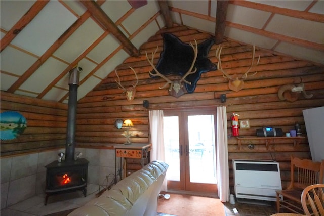 living room with french doors, high vaulted ceiling, heating unit, and a wood stove