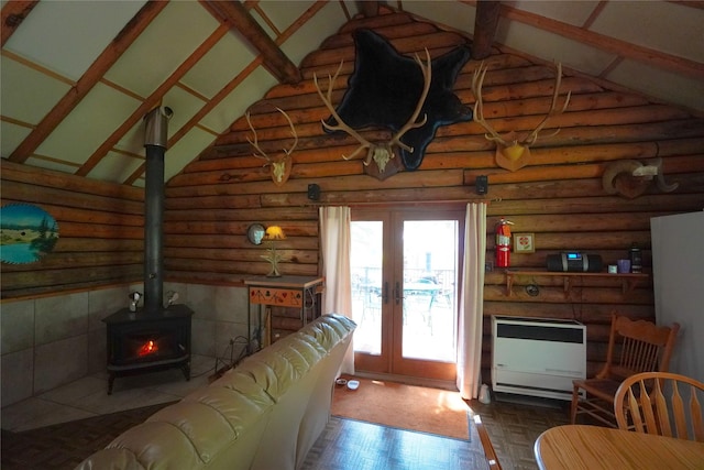 living room featuring french doors, high vaulted ceiling, heating unit, and a wood stove