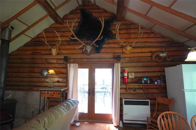 living room featuring heating unit, high vaulted ceiling, french doors, and a wood stove