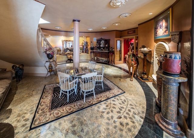 interior space featuring ornamental molding, dark tile floors, and ornate columns