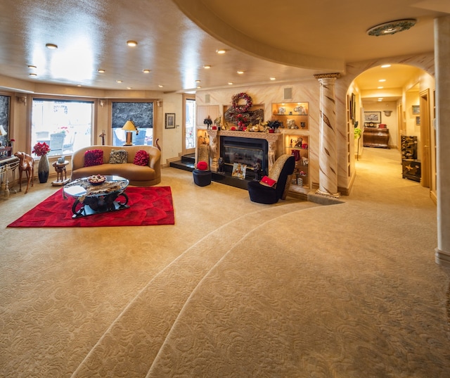 carpeted living room featuring ornate columns