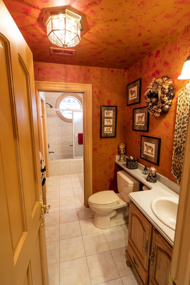 bathroom featuring tile flooring, toilet, and vanity