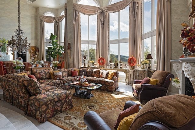 tiled living room with an inviting chandelier, a premium fireplace, and a towering ceiling