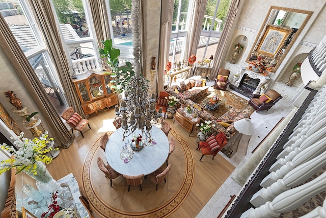 living room featuring light hardwood / wood-style floors and a towering ceiling