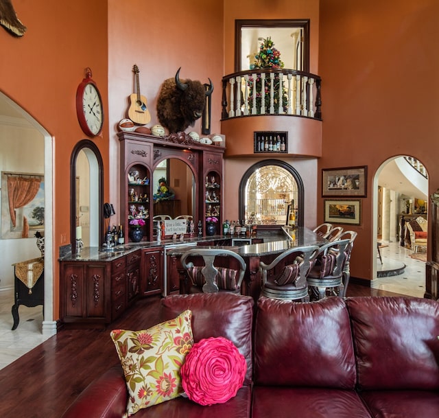 living room featuring hardwood / wood-style floors and a high ceiling