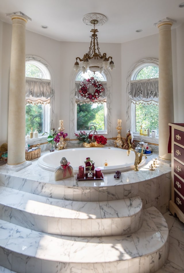 bathroom featuring plenty of natural light and ornate columns