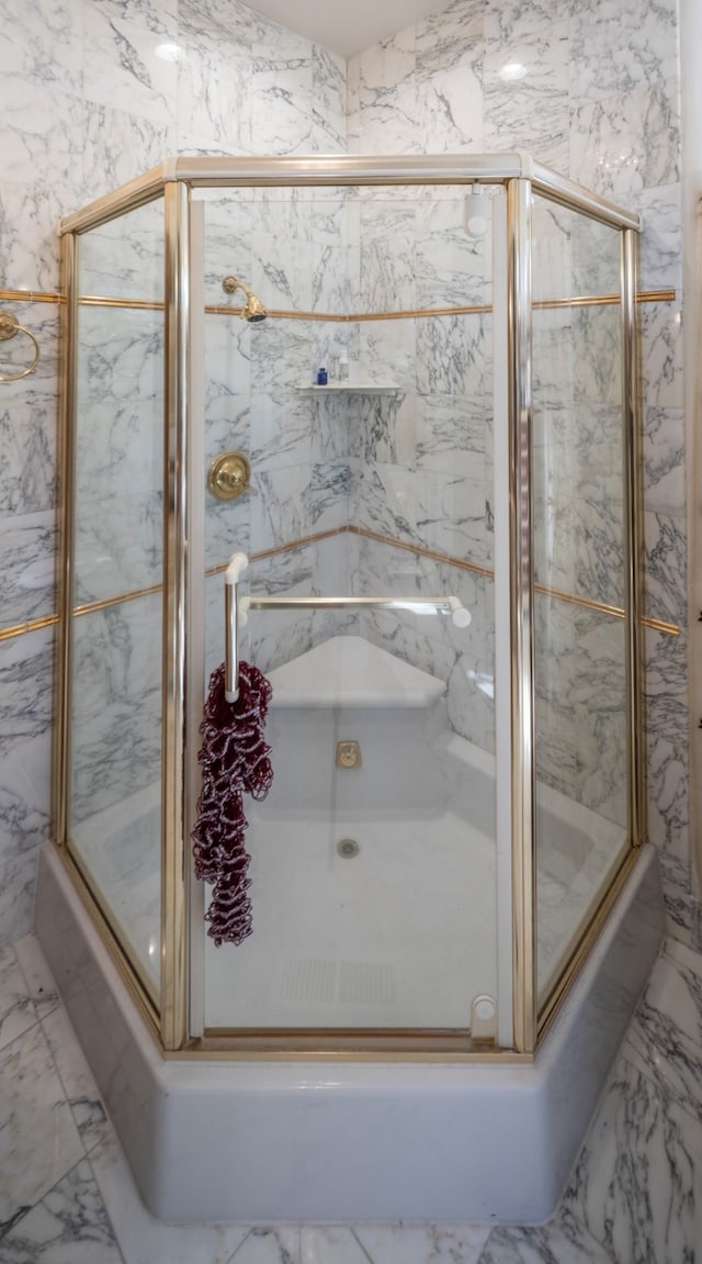 bathroom with tile walls and tile flooring