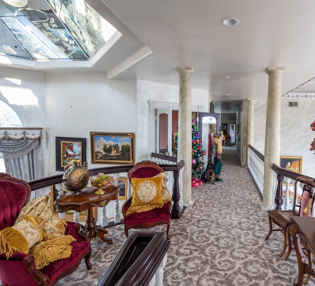 carpeted living room featuring decorative columns