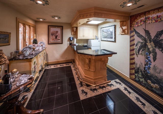 bar featuring white fridge and dark tile flooring