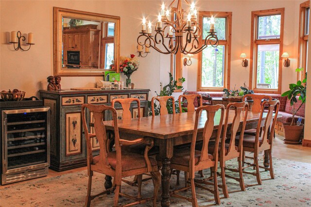 kitchen featuring beamed ceiling, light wood-type flooring, and beverage cooler