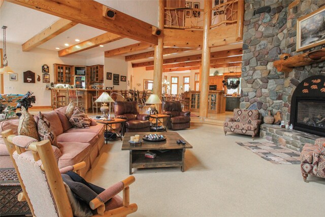 recreation room with billiards, indoor bar, a stone fireplace, beamed ceiling, and light hardwood / wood-style floors