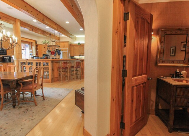 dining room with wine cooler and light wood-type flooring