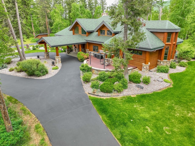 back of house with a patio and a yard