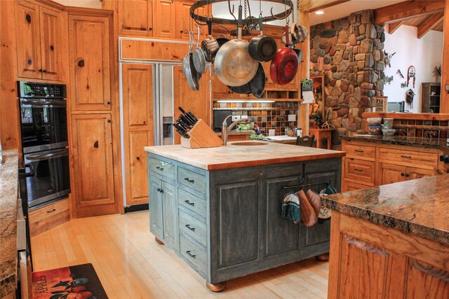 kitchen with a healthy amount of sunlight, hanging light fixtures, and a kitchen island