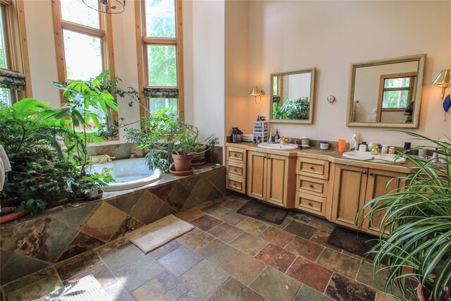 kitchen featuring sink, butcher block countertops, light hardwood / wood-style flooring, and black double oven