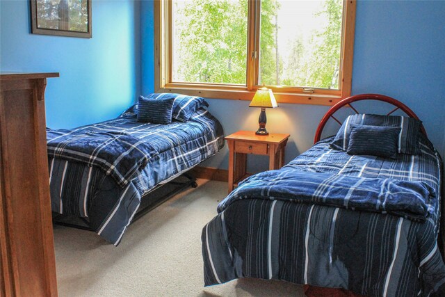 bedroom with vaulted ceiling, light carpet, and ceiling fan