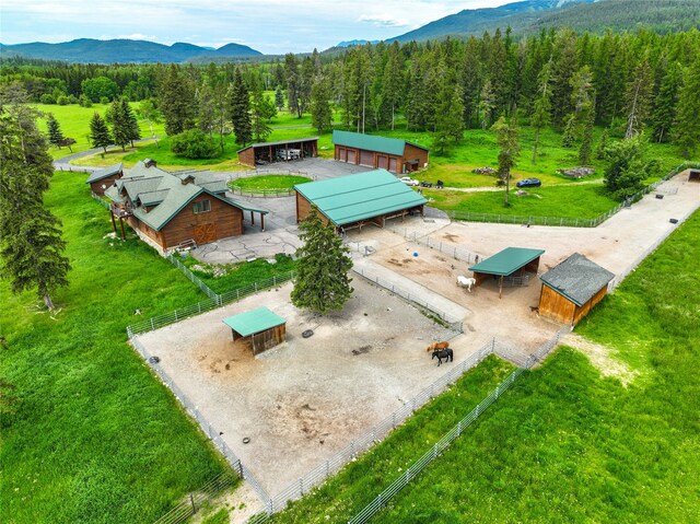 birds eye view of property with a water and mountain view