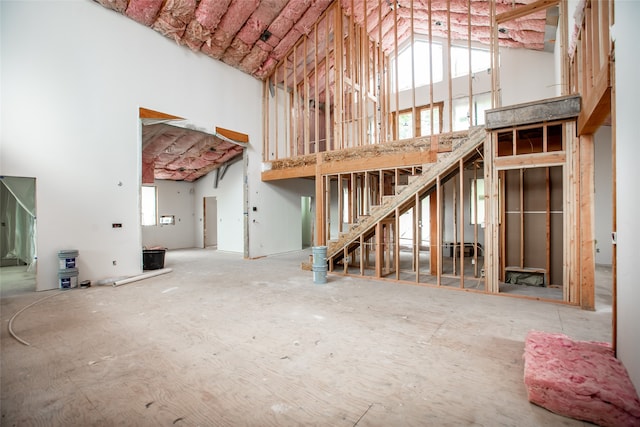 misc room featuring plenty of natural light and a towering ceiling